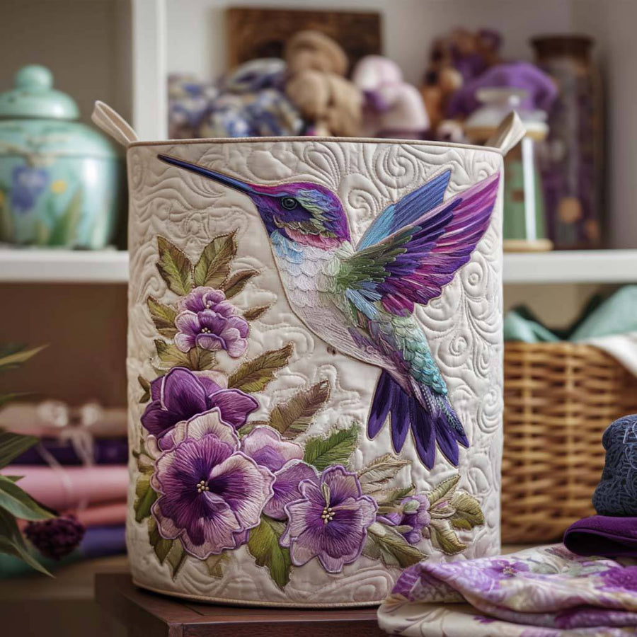 Hummingbird in Bloom quilted laundry basket by THE WHITMORE FAMILY with floral bird design and soft fabric quilting.