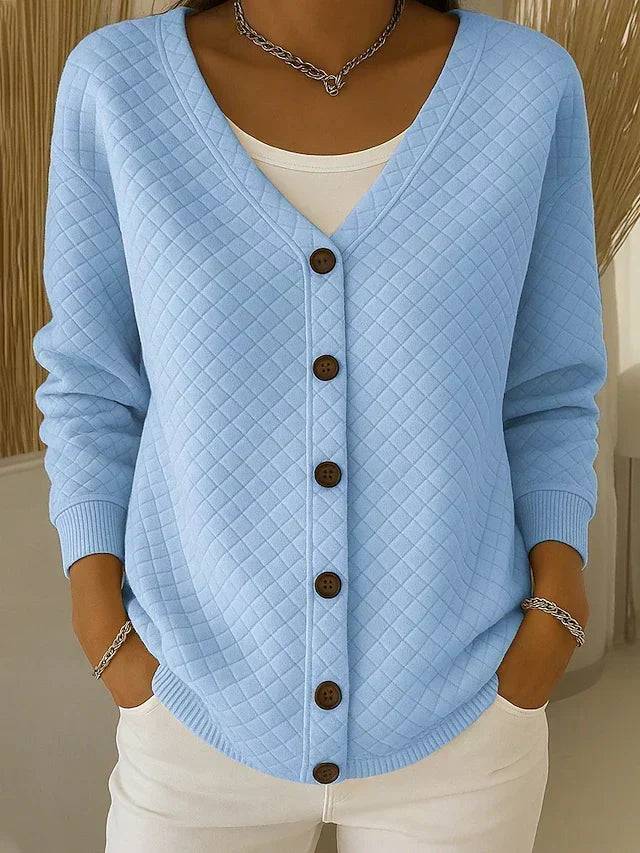 Janice Blue Laverne™ quilted button-front cardigan by THE WHITMORE FAMILY, featuring a textured quilted pattern and button closure.