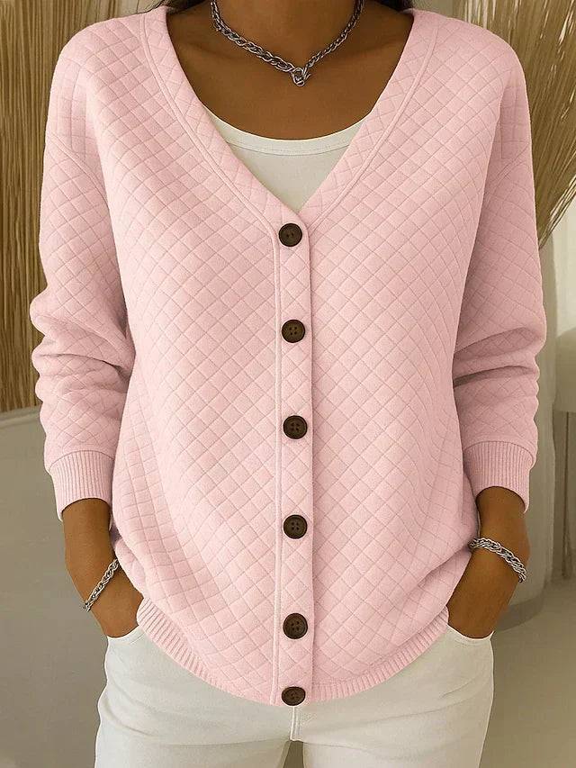 Pink quilted Laverne™ cardigan with button-front design from THE WHITMORE FAMILY, shown on a model.