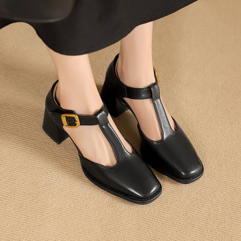 Marcele T-Strap leather pumps by THE WHITMORE FAMILY, showcasing the elegant black T-strap design and sleek leather finish.