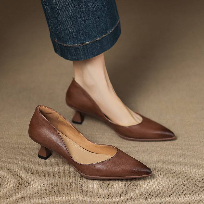 Calenne leather kitten heels by THE WHITMORE FAMILY, featuring a stylish pointed toe and sleek black leather finish.