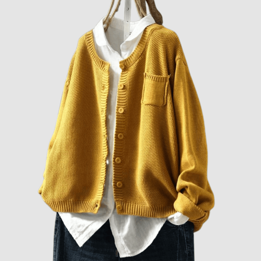 Berlinda™ Cozy Knit Cardigan from THE WHITMORE FAMILY, soft beige knit with button closure and relaxed fit, displayed on a hanger