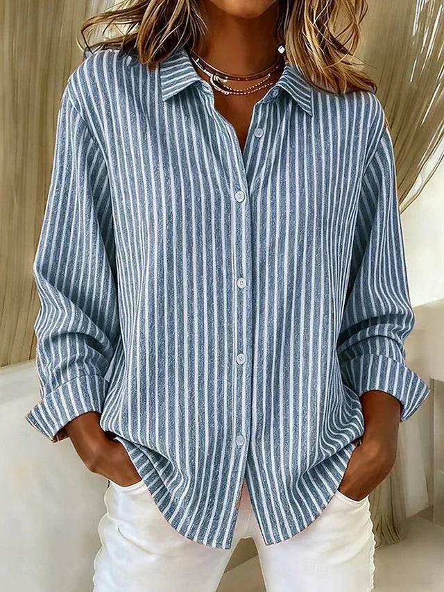 Rebecca wearing the Jacqueline™ striped button-down shirt in blue, featuring a classic collar and long sleeves.