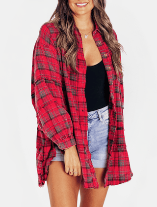 Red women's oversized flannel shirt with raw hem and long sleeves, casual blouse by THE WHITMORE FAMILY.