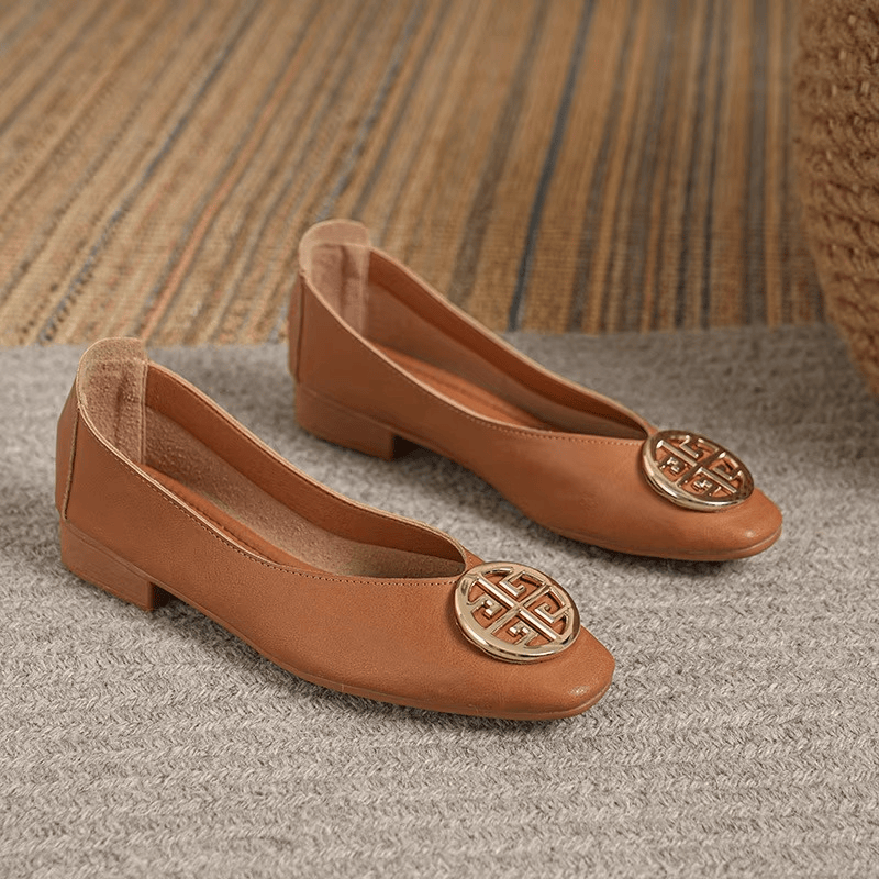 Orchard Leather Flats by THE WHITMORE FAMILY, stylish tan leather slip-on shoes with a rounded toe and sleek design.