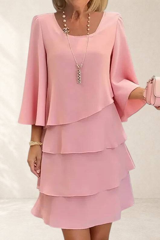 Elegant Comfort Catherine Ruffle Dress by THE WHITMORE FAMILY, featuring a stylish ruffled design and flowing fabric.
