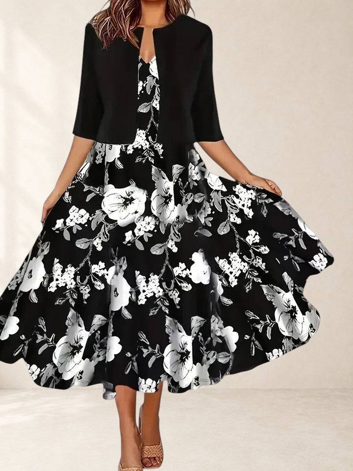 Elegant midi dress by THE WHITMORE FAMILY featuring a fitted silhouette and stylish design, shown on a model.