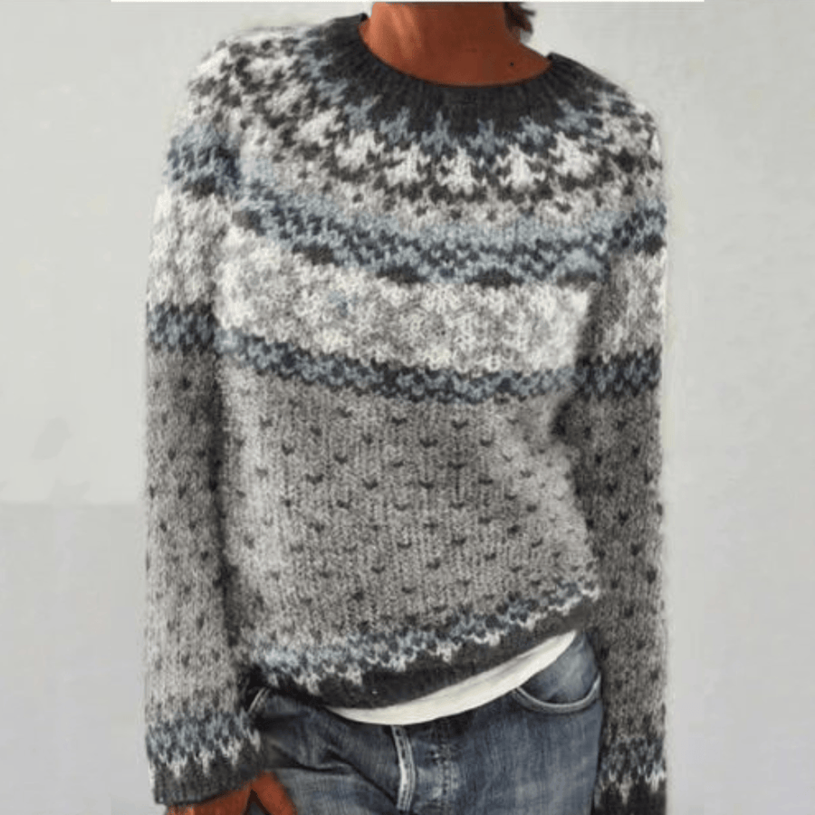 Scandinavian knitted sweater named Clara by THE WHITMORE FAMILY, in gray with a retro design, displayed on a hanger.