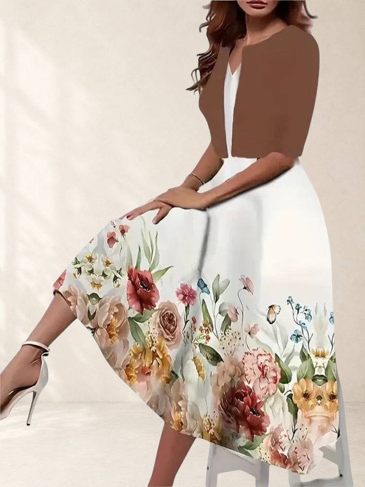 Elegant midi dress by THE WHITMORE FAMILY featuring a fitted bodice and flowing skirt in a sophisticated design.