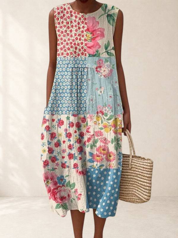Anna patchwork midi dress by THE WHITMORE FAMILY displayed on a hanger, showcasing its colorful patchwork design and midi length.