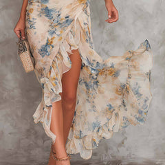 Cora floral maxi dress by THE WHITMORE FAMILY, flowing fabric with vibrant floral pattern, full-length dress on a hanger.