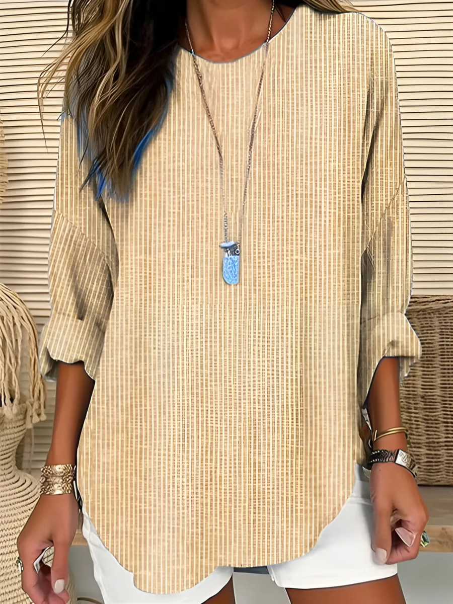 Trendy striped blouse named Rhea by THE WHITMORE FAMILY, featuring a stylish pattern and casual fit, shown on a model.