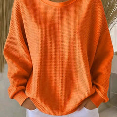 Women's classic sweater jumper by THE WHITMORE FAMILY, soft knit fabric, in a neutral color, displayed on a hanger.