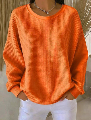 Women's classic sweater jumper by THE WHITMORE FAMILY, soft knit fabric, in a neutral color, displayed on a hanger.