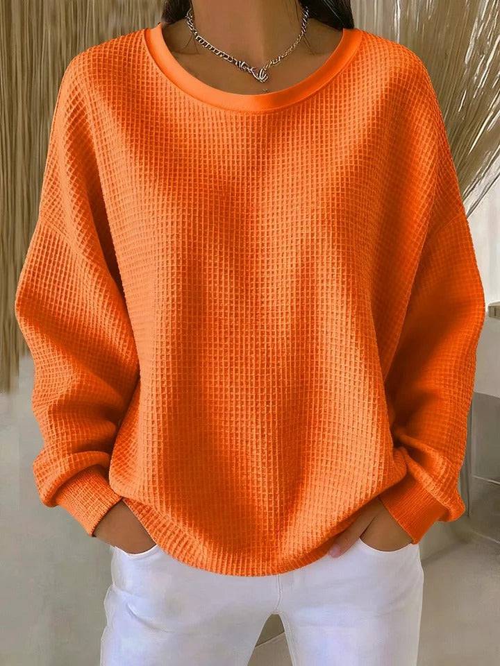Women's classic sweater jumper by THE WHITMORE FAMILY, soft knit fabric, in a neutral color, displayed on a hanger.