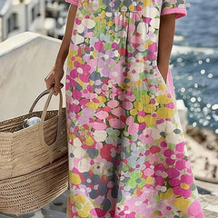 Elegant floral summer midi dress by THE WHITMORE FAMILY, featuring a flowing design and vibrant floral pattern.