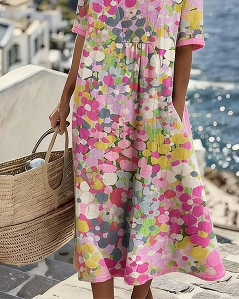 Elegant floral summer midi dress by THE WHITMORE FAMILY, featuring a flowing design and vibrant floral pattern.