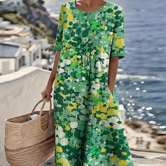 Elegant floral summer midi dress by THE WHITMORE FAMILY, featuring a flowing design with vibrant floral patterns.