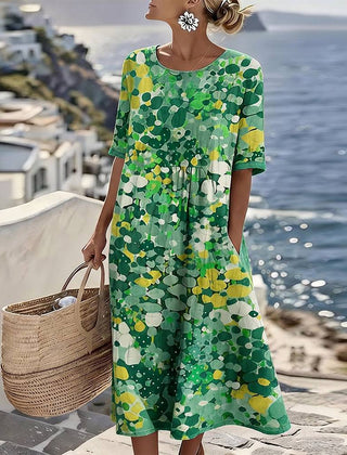 Elegant floral summer midi dress by THE WHITMORE FAMILY, featuring a flowing design with vibrant floral patterns.