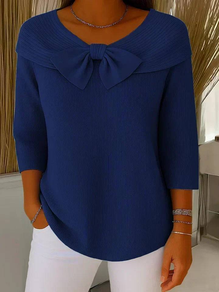 Women’s sweater with round neckline and bow detail by THE WHITMORE FAMILY, featuring a cozy knit fabric and classic fit.