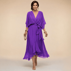 Mona V-neck dress by THE WHITMORE FAMILY featuring a stylish V-neckline and elegant silhouette.
