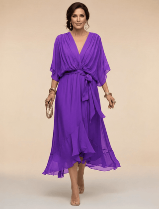 Mona V-neck dress by THE WHITMORE FAMILY featuring a stylish V-neckline and elegant silhouette.