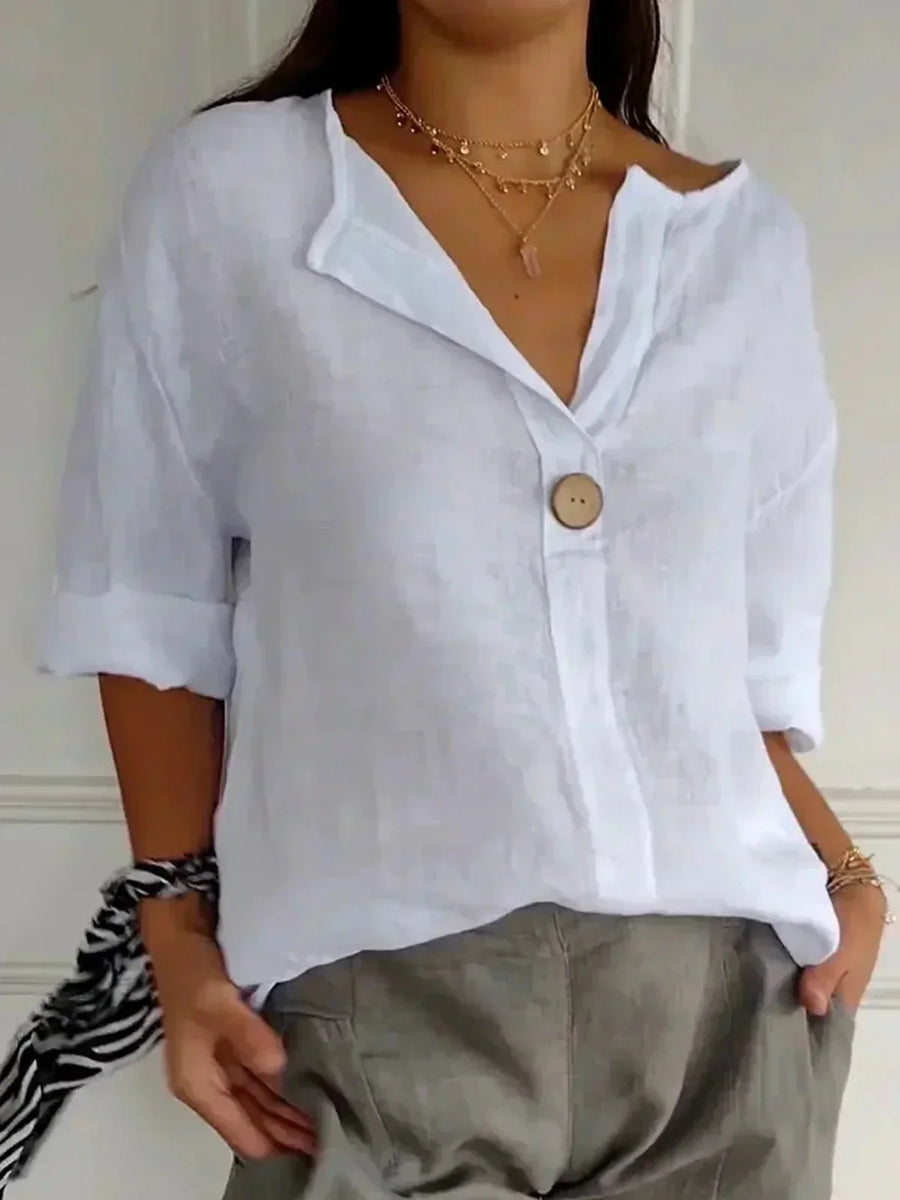 Relaxed V-neck top by THE WHITMORE FAMILY featuring a comfortable fit and soft fabric, shown on a model.