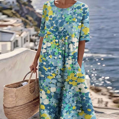Elegant floral summer midi dress by THE WHITMORE FAMILY featuring a flowing silhouette and vibrant floral pattern.