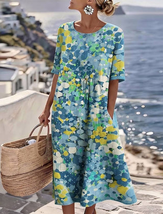 Elegant floral summer midi dress by THE WHITMORE FAMILY featuring a flowing silhouette and vibrant floral pattern.