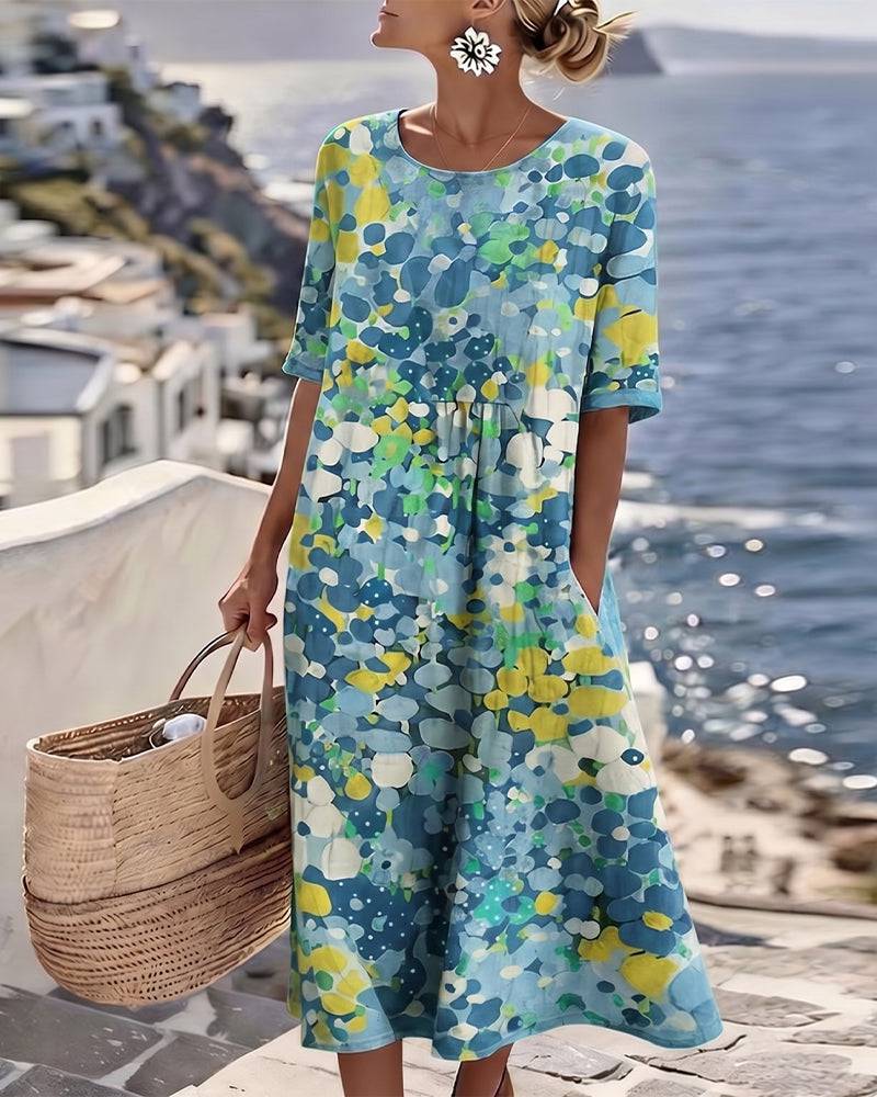 Elegant floral summer midi dress by THE WHITMORE FAMILY featuring a flowing silhouette and vibrant floral pattern.