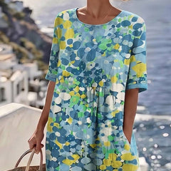 Elegant floral summer midi dress from THE WHITMORE FAMILY featuring a flowing silhouette and vibrant floral pattern.