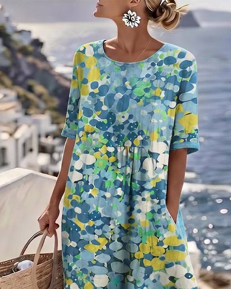 Elegant floral summer midi dress from THE WHITMORE FAMILY featuring a flowing silhouette and vibrant floral pattern.