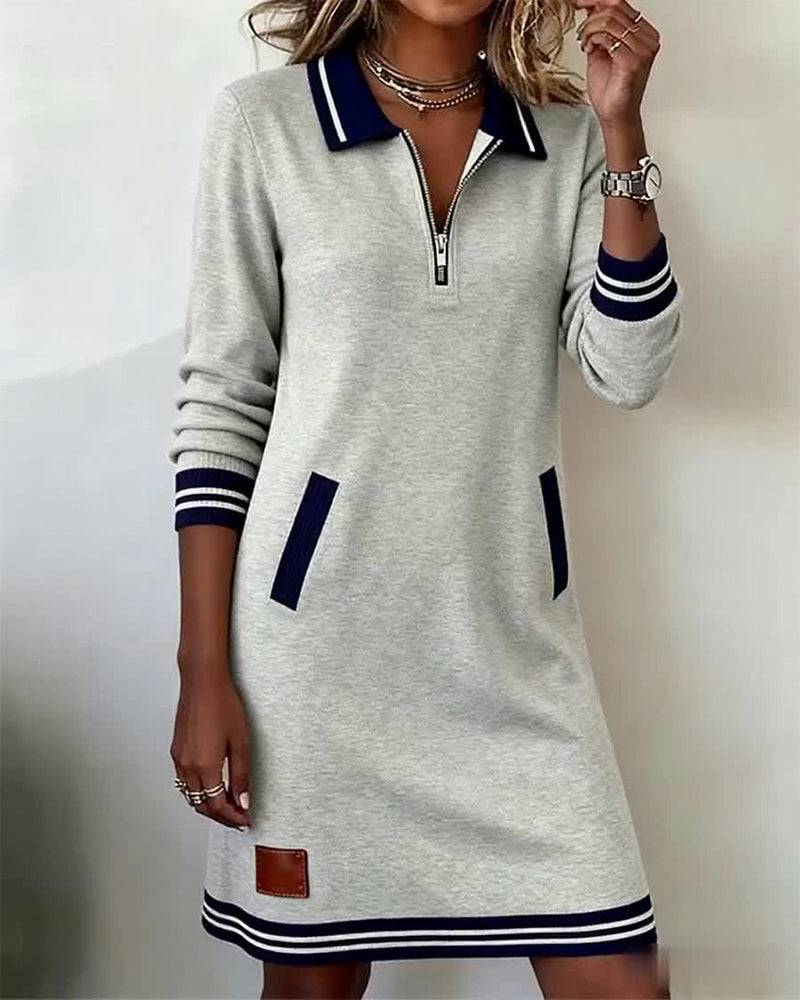 Dorellia casual long sleeve dress with zip closure by THE WHITMORE FAMILY, shown in a relaxed fit with a front zipper detail.