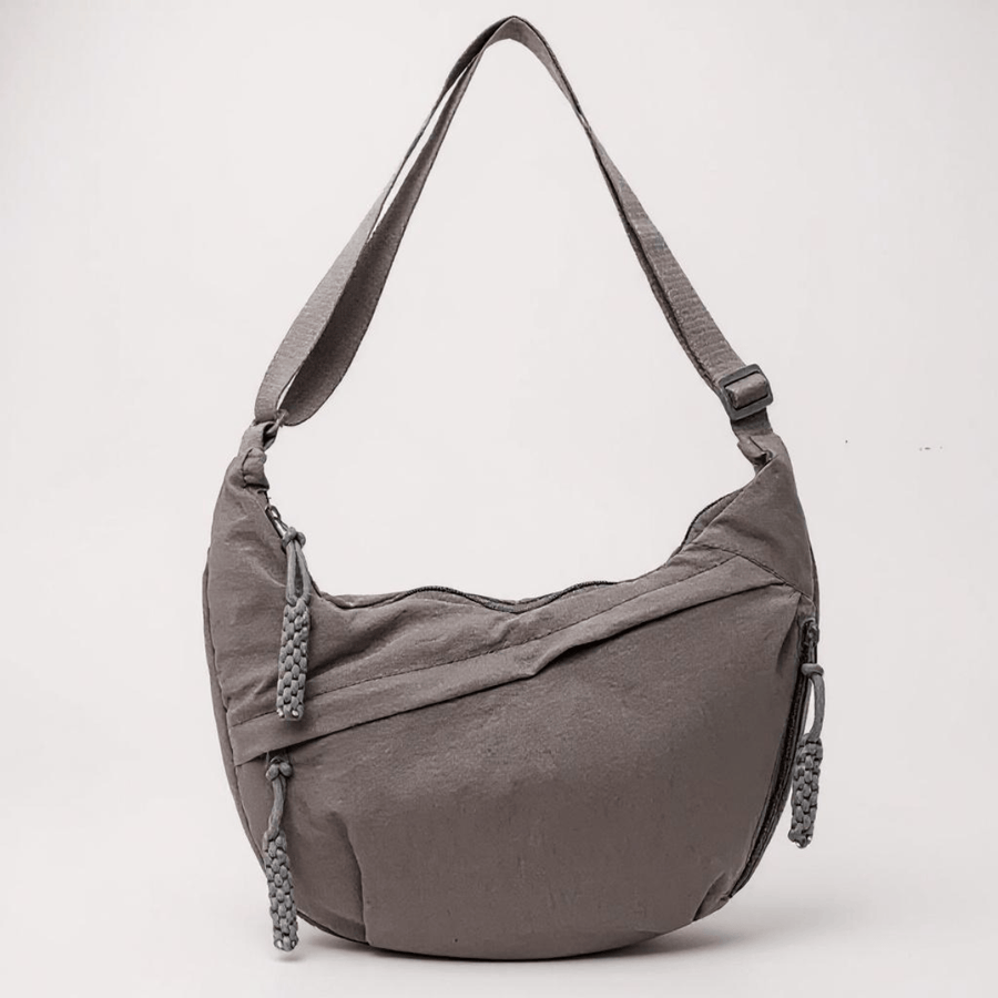 Gray Chiara shoulder bag by THE WHITMORE FAMILY, featuring a sleek design with a structured silhouette and shoulder strap.