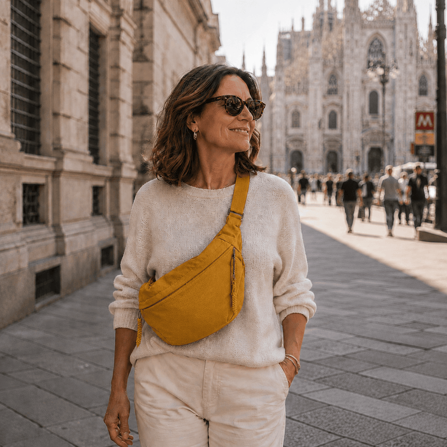 Luce mustard crossbody bag by THE WHITMORE FAMILY with adjustable strap and stylish design, displayed on a neutral background.