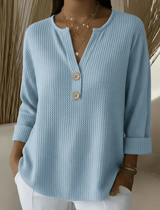 Women’s Henley button sweater by THE WHITMORE FAMILY, featuring a cozy knit fabric and classic henley neckline.