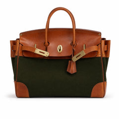 Green The Eleanor Weekender bag by THE WHITMORE FAMILY showing its spacious design and sturdy handles.