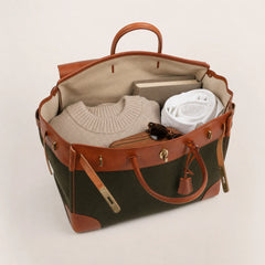 Green Eleanor Weekender bag by THE WHITMORE FAMILY, showing a spacious, stylish travel tote with leather accents and sturdy handles.