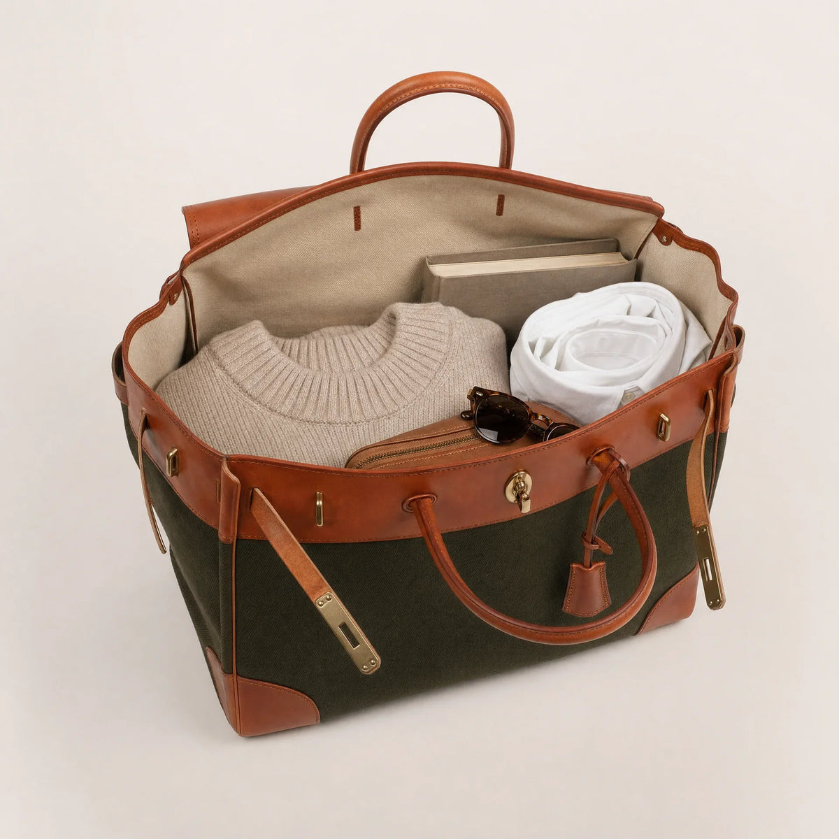 Green Eleanor Weekender bag by THE WHITMORE FAMILY, showing a spacious, stylish travel tote with leather accents and sturdy handles.