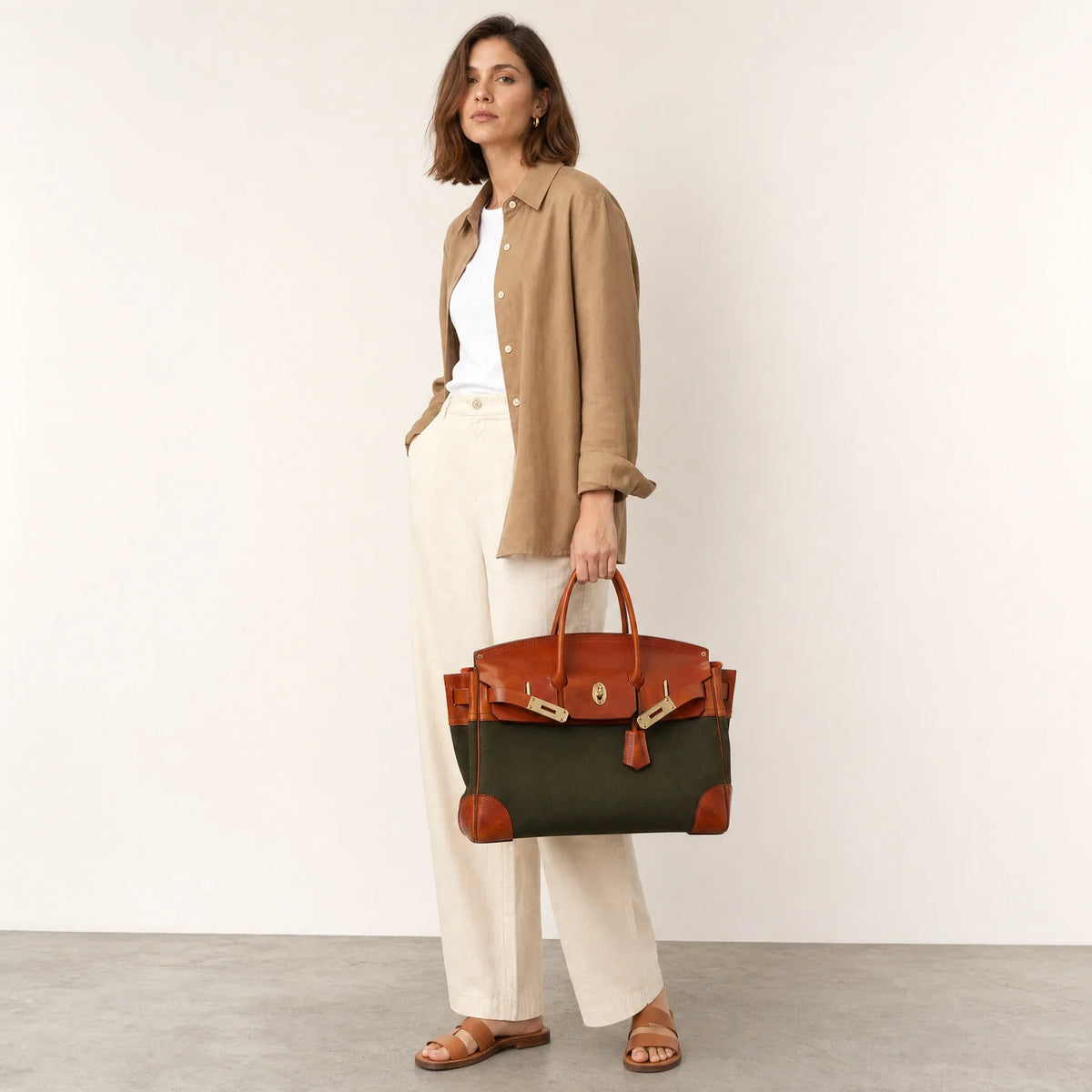 Green Eleanor Weekender bag by THE WHITMORE FAMILY with sturdy handles and spacious interior for travel and weekend trips.