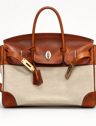 The Eleanor Weekender bag from THE WHITMORE FAMILY featuring durable canvas material and leather accents, perfect for travel.