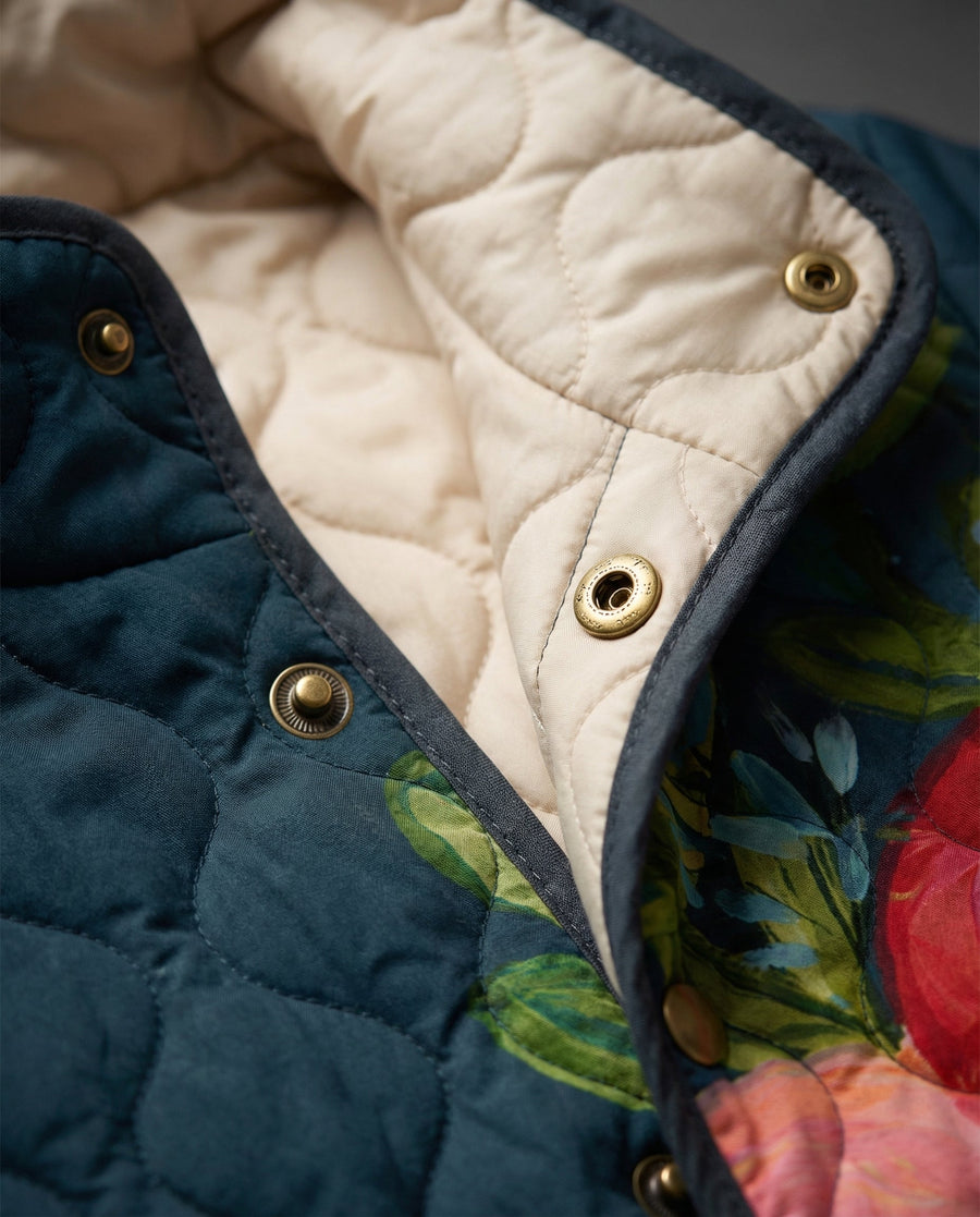 Vintage floral print quilted jacket by THE WHITMORE FAMILY, featuring a cozy design with colorful floral patterns and quilted details.