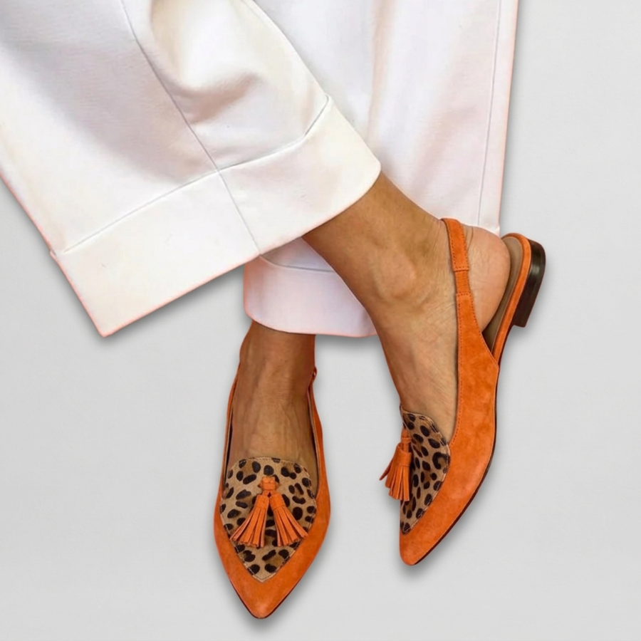 Eliza sandals by THE WHITMORE FAMILY featuring strappy design with tassels, shown in a close-up view of the footwear.