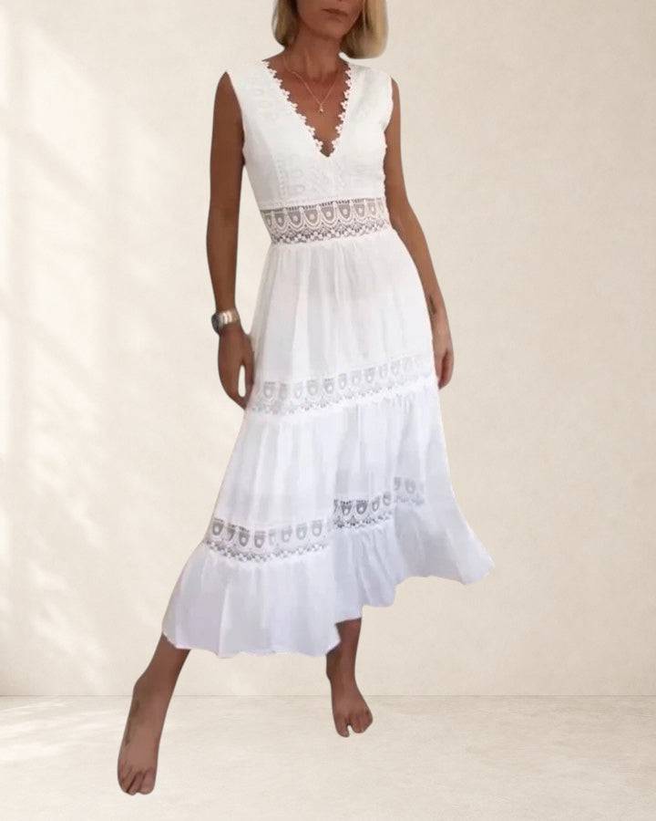 Elegant midi dress from THE WHITMORE FAMILY featuring a fitted silhouette and stylish design, shown on a model.