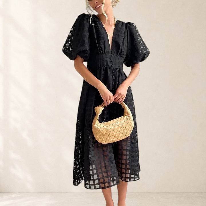Elegant midi dress by THE WHITMORE FAMILY featuring a flowing silhouette and sophisticated design.