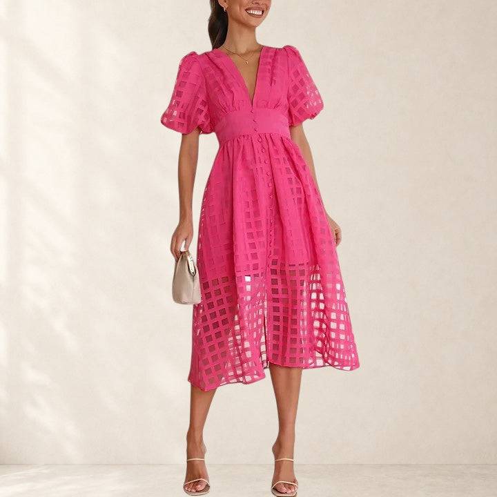 Elegant midi dress by THE WHITMORE FAMILY featuring a fitted bodice and flowing skirt in a sophisticated style.