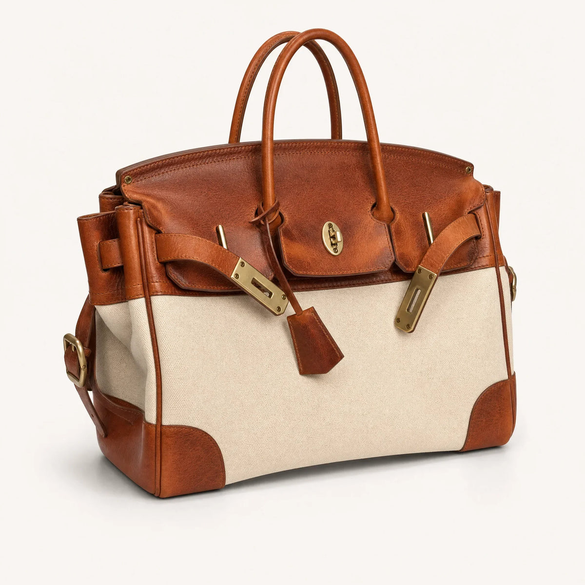 The Eleanor Weekender by THE WHITMORE FAMILY features a stylish, spacious tote bag with leather handles and a neutral fabric design.