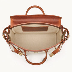 The Eleanor Weekender bag by THE WHITMORE FAMILY, showing a stylish leather travel bag with handles and a spacious interior.