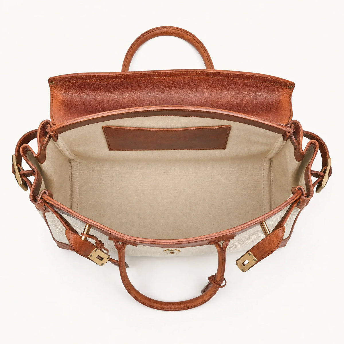 The Eleanor Weekender bag by THE WHITMORE FAMILY, showing a stylish leather travel bag with handles and a spacious interior.