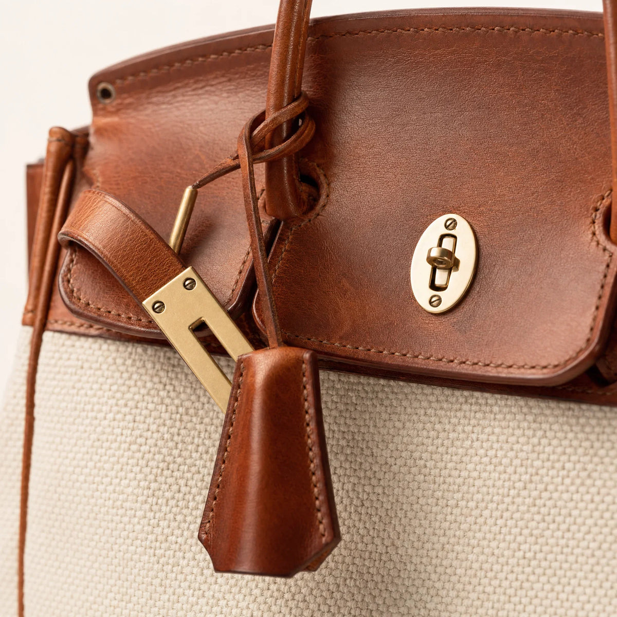 The Eleanor Weekender bag by THE WHITMORE FAMILY, showing a spacious canvas travel tote with leather handles and minimal design.